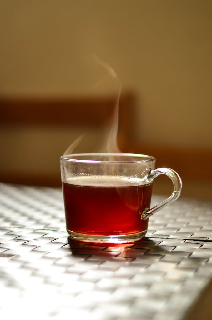Wendy"s drinks: A steaming glass of tea adds warmth to an indoor setting, captured in a modern style.